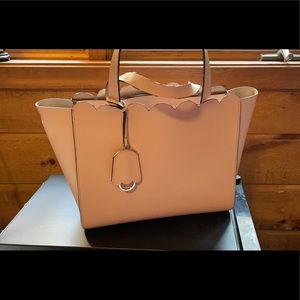 Kate Spade pink purse with zipper closing.